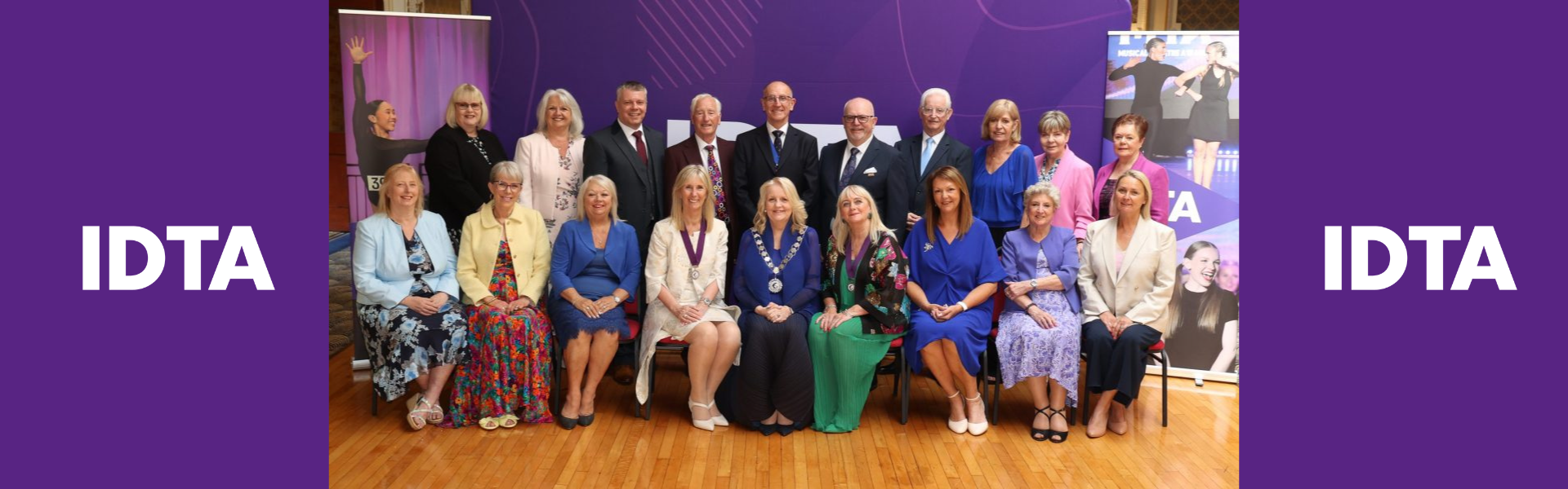 people standing and sitting for a photoshoot